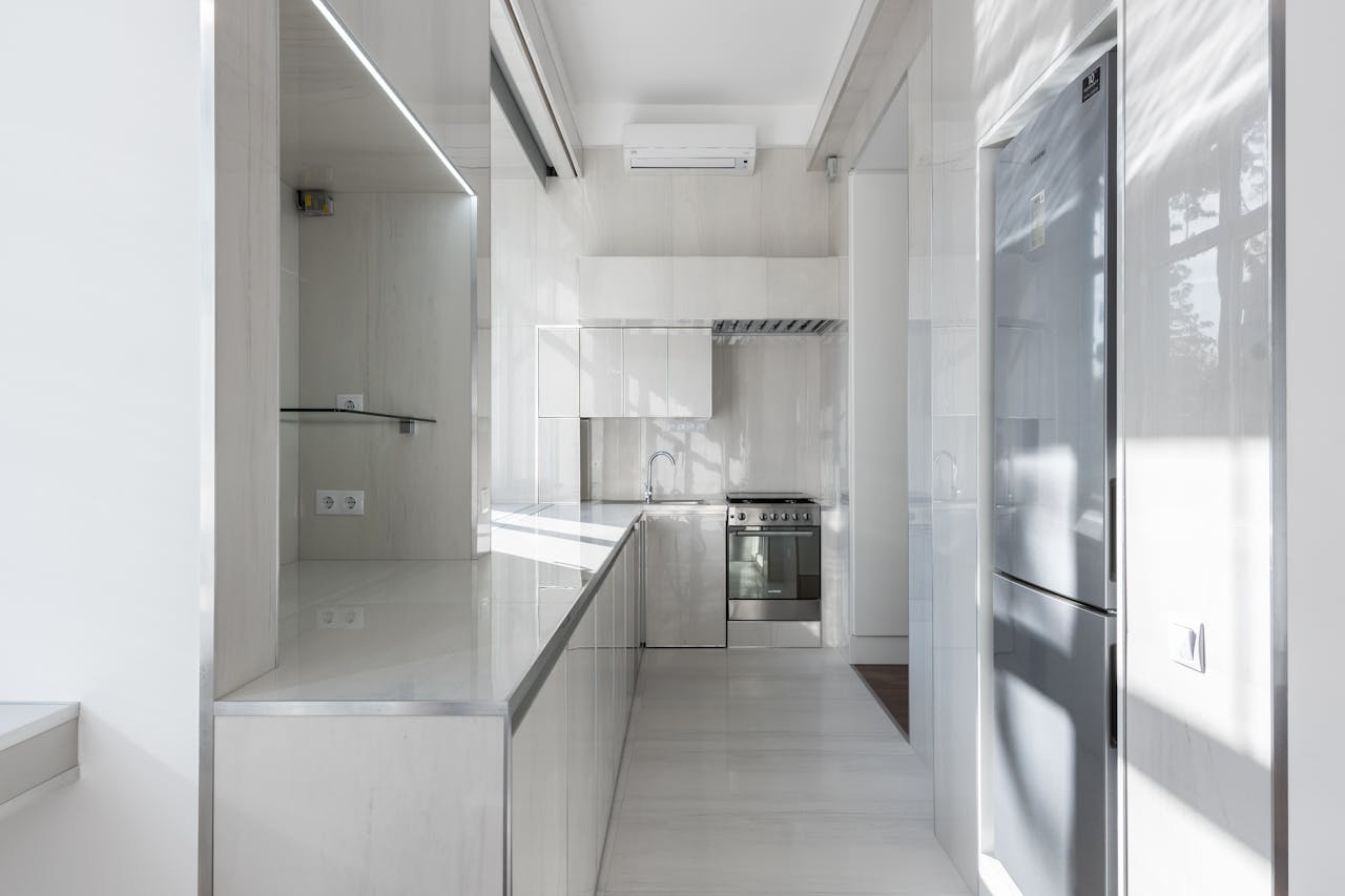 services-img Bright and modern kitchen interior with minimalist design and sleek appliances.